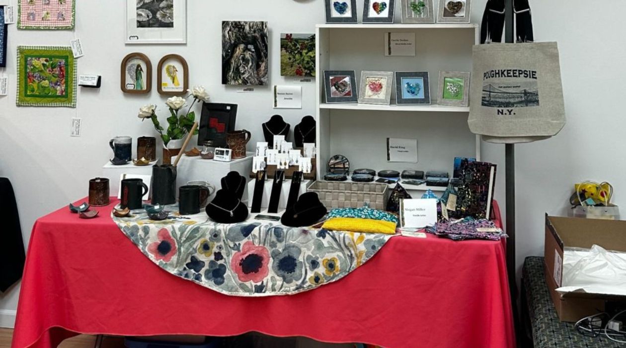 A vendor table at the Dutchess Handmade Pop-Up Shop in Poughkeepsie, including jewelry items and picture frames.